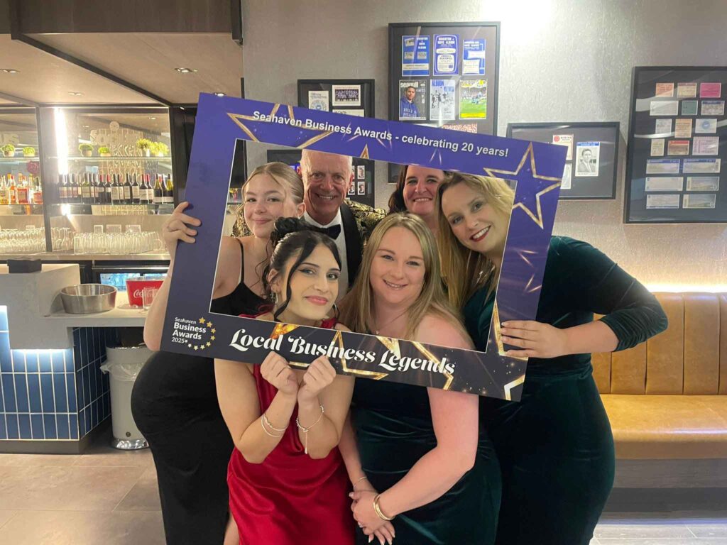 people holding up a photo sign for Seahaven business awards