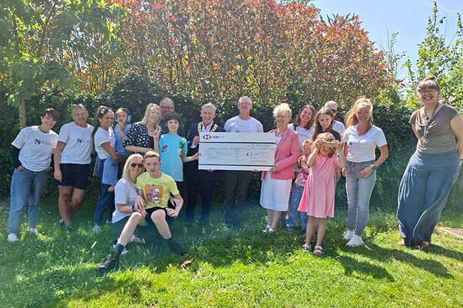 charity cheque presentation in garden of charity